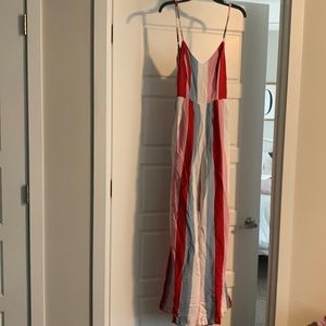 Brand New rainbow jumpsuit. Still has tags! Tie strings for open back.Size small